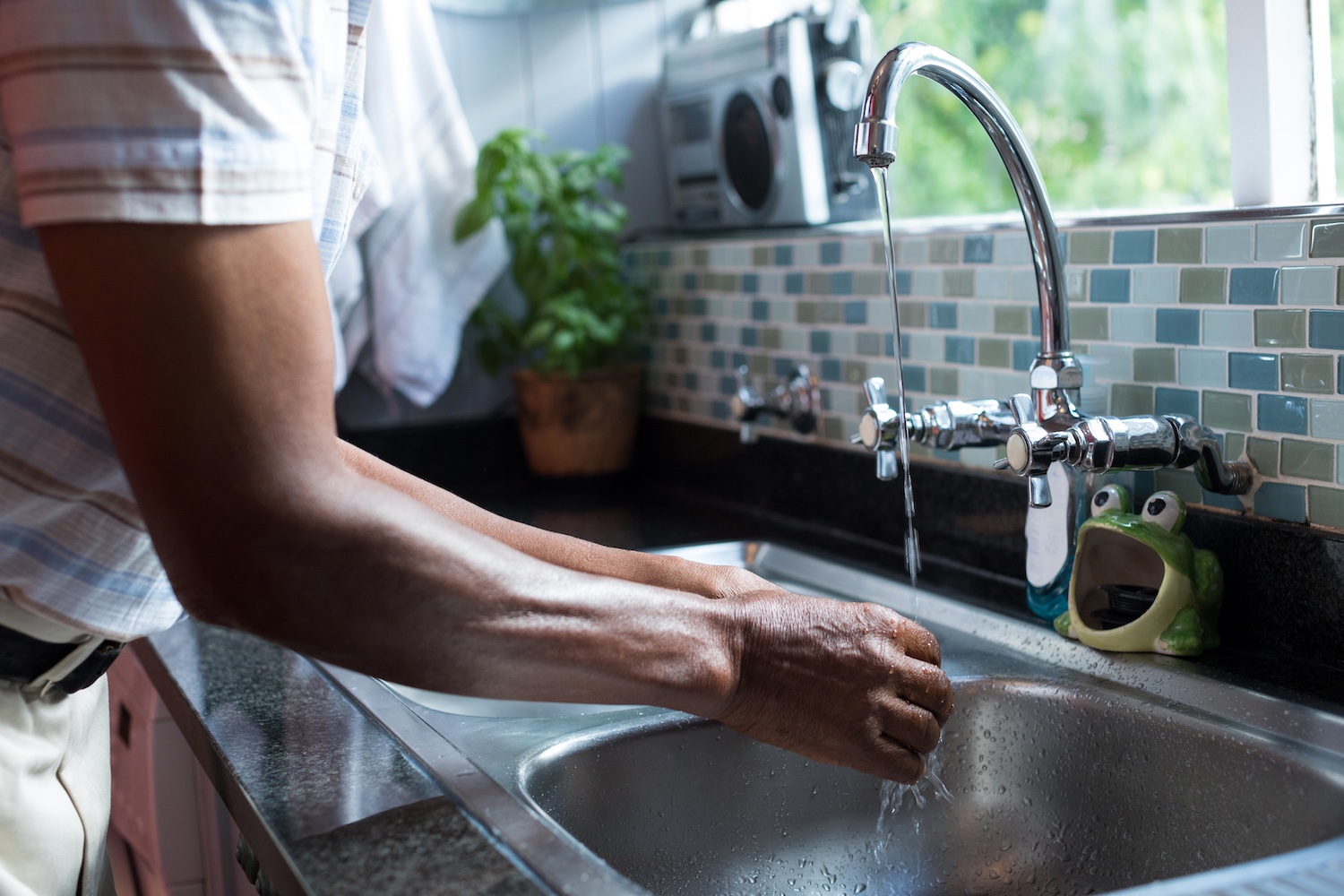midsection of man washing hands 2025 04 03 09 24 32 utc
